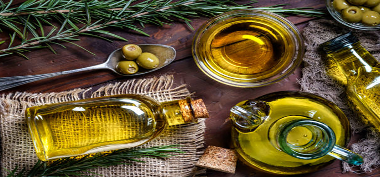 top view of olives and olive oil bottles on table