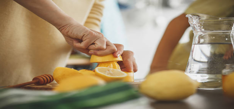 women squeezing lemon