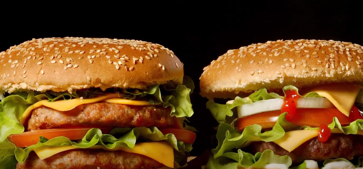 2 burgers on a black background