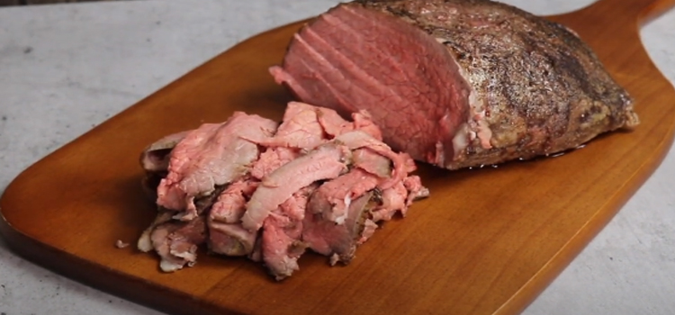 deli roast beef on a wooden chopping board