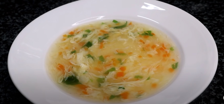 egg drop soup in a white soup plate