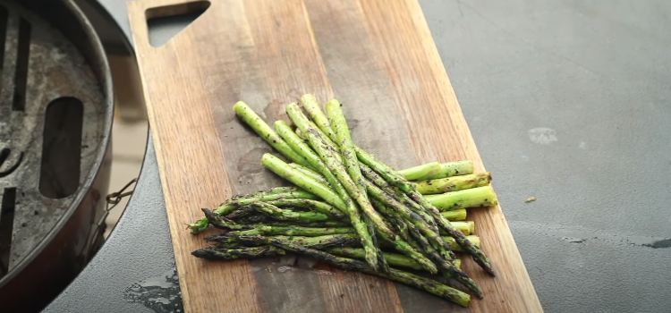 grilled asparagus on a wooden board