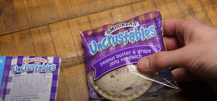 hand holding uncrustables soft bread