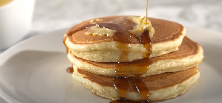 pancake with syrup on a white plate