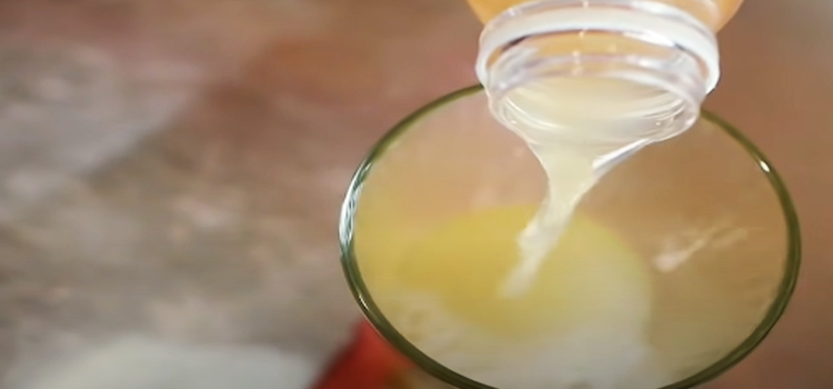 pouring vinegar on a glass