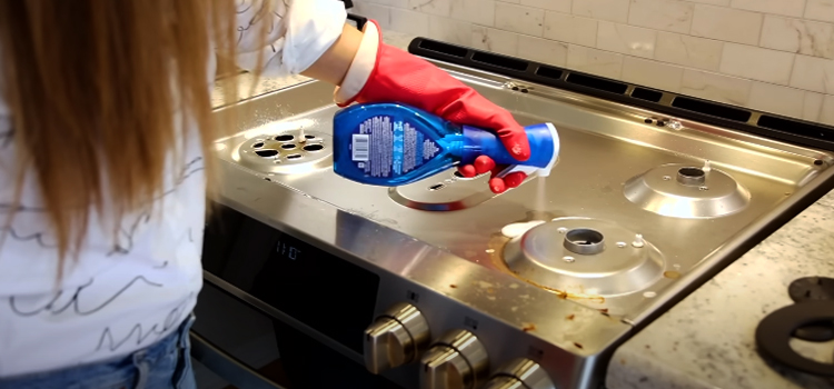 woman cleaning stove