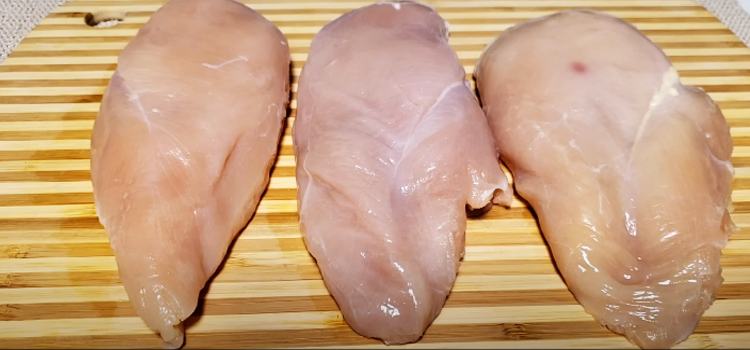 chicken breast on top of a wooden board