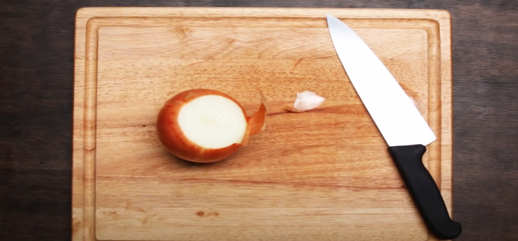 chopping onion on a wooden board