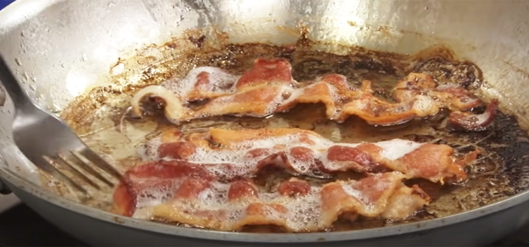 cooking bacon in a pan