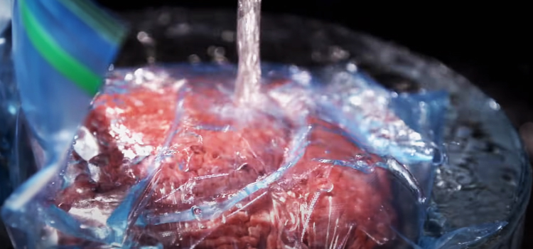 defrosting meat on a running water