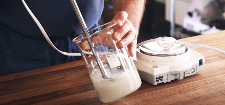 guy mixing Xanthan Gum on a water