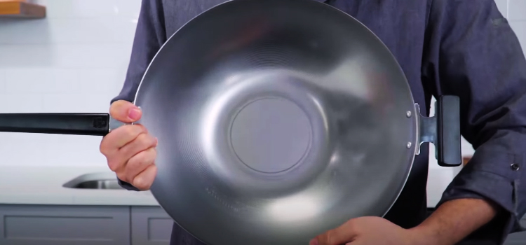 man holding a wok