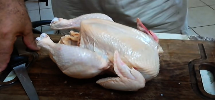 whole chicken on a wooden board