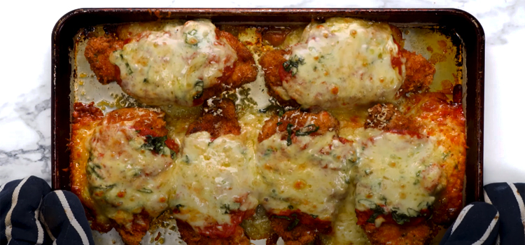 Chicken Parmigiana on a baking pan