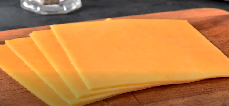 Slices of Cheese on a Wooden Board