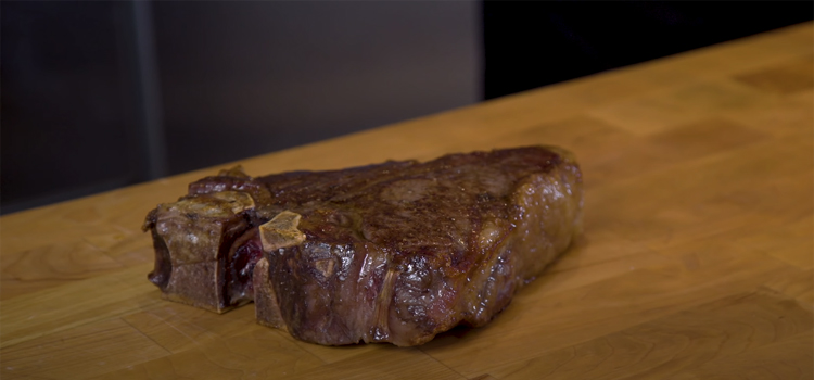 cooked steak meat on a wooden table