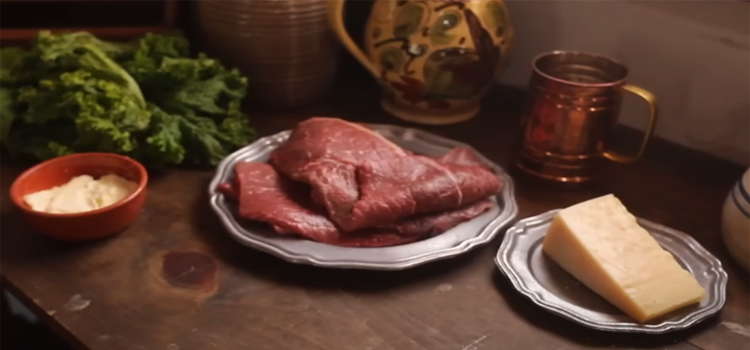 meat and cheese on top of a wooden table