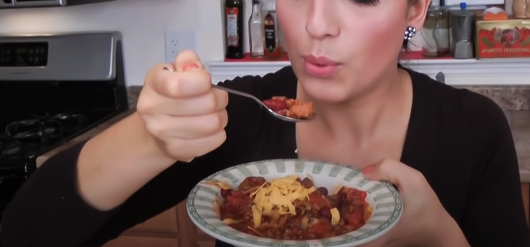 woman eating chili