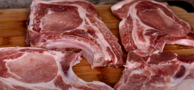 Close Up Shot of Pork Chops on a Wooden Board