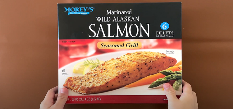 Hand Holding Box of Costco's Marinated Salmon