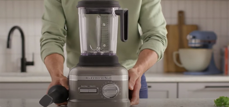 man carrying a blender