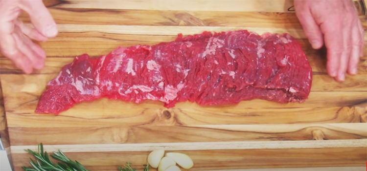 skirt steak on a wooden board