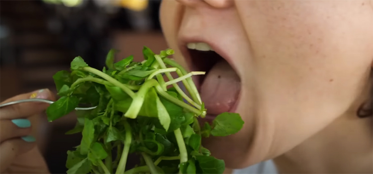 woman eating spinach