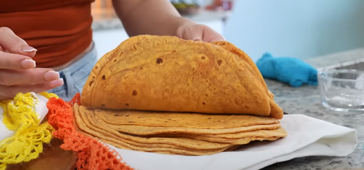 woman holding flour tortillas