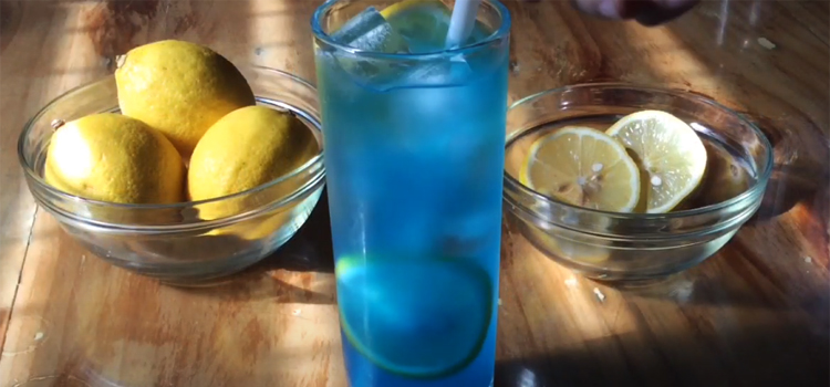 Glass of Blue Lemonade and Lemons