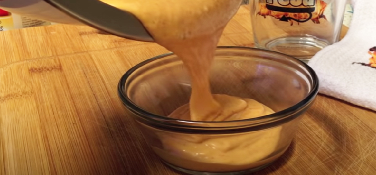 Pouring Zesty Sauce on a Bowl