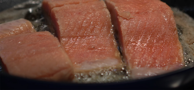 cooking salmon in a pan