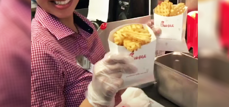 woman holding Chick Fil A Fries