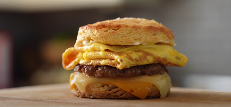 Bacon, Sausage, Egg & Cheese Biscuit on a Wooden Board