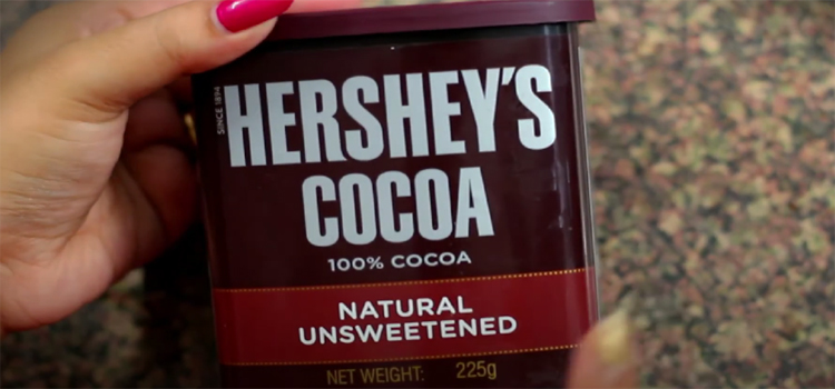 Hand Holding Can of Hershey's Unsweetened Cocoa Powder