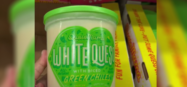 Hand Holding Jar of Queso Mama White Queso with Diced Green Chilies