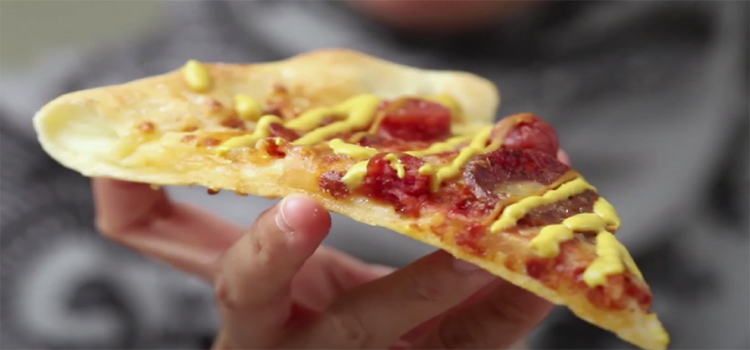 Hand Holding Sliced of Pizza Hut Original Stuffed Crust