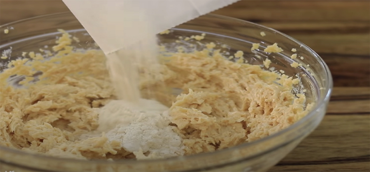 Pouring Flour on a Cookie Dough