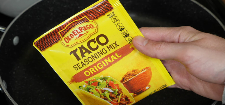 Hand Holding Sachet of Old El Paso Original Taco Seasoning Mix