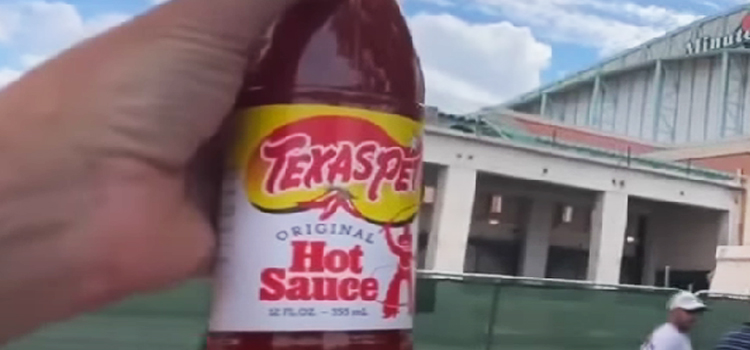 Hand Holding Texas Pete Hot Sauce