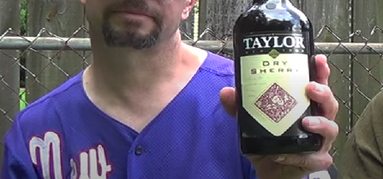 Man Holding Bottle of Taylor Dry Sherry