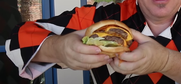 Man Holding In-N-Out Animal Style Hamburger