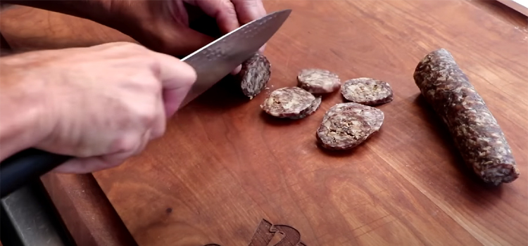 Slicing Salami on a Wooden Board