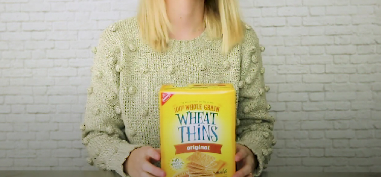 Woman Holding Box of Wheat Thins