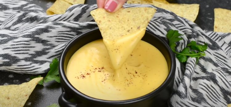 Dipping Chip on a Cheese Sauce