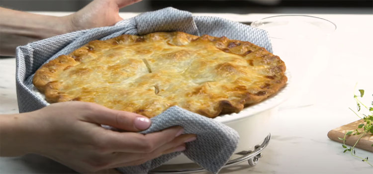 Hands Holding Bowl of Chicken Pot Pie