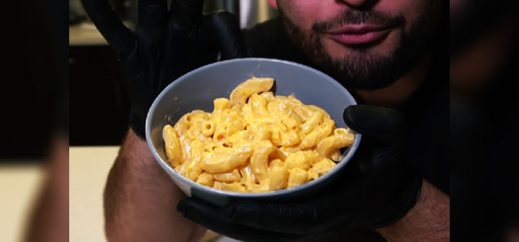 Man Holding Bowl of Mac and Cheese