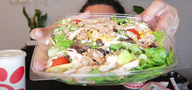 Woman Holding Chick Fil A Spicy Southwest Salad on a Tub