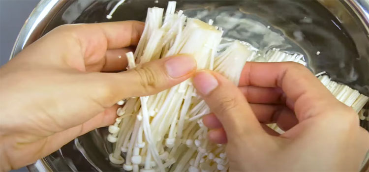 Person Cleaning Enoki Mushrooms