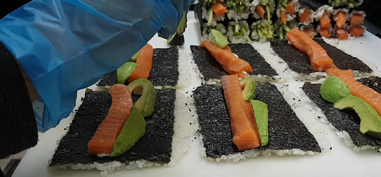 Person Making Salmon Avocado Roll