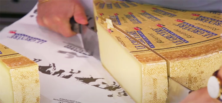 Person Slicing Gruyere Cheese